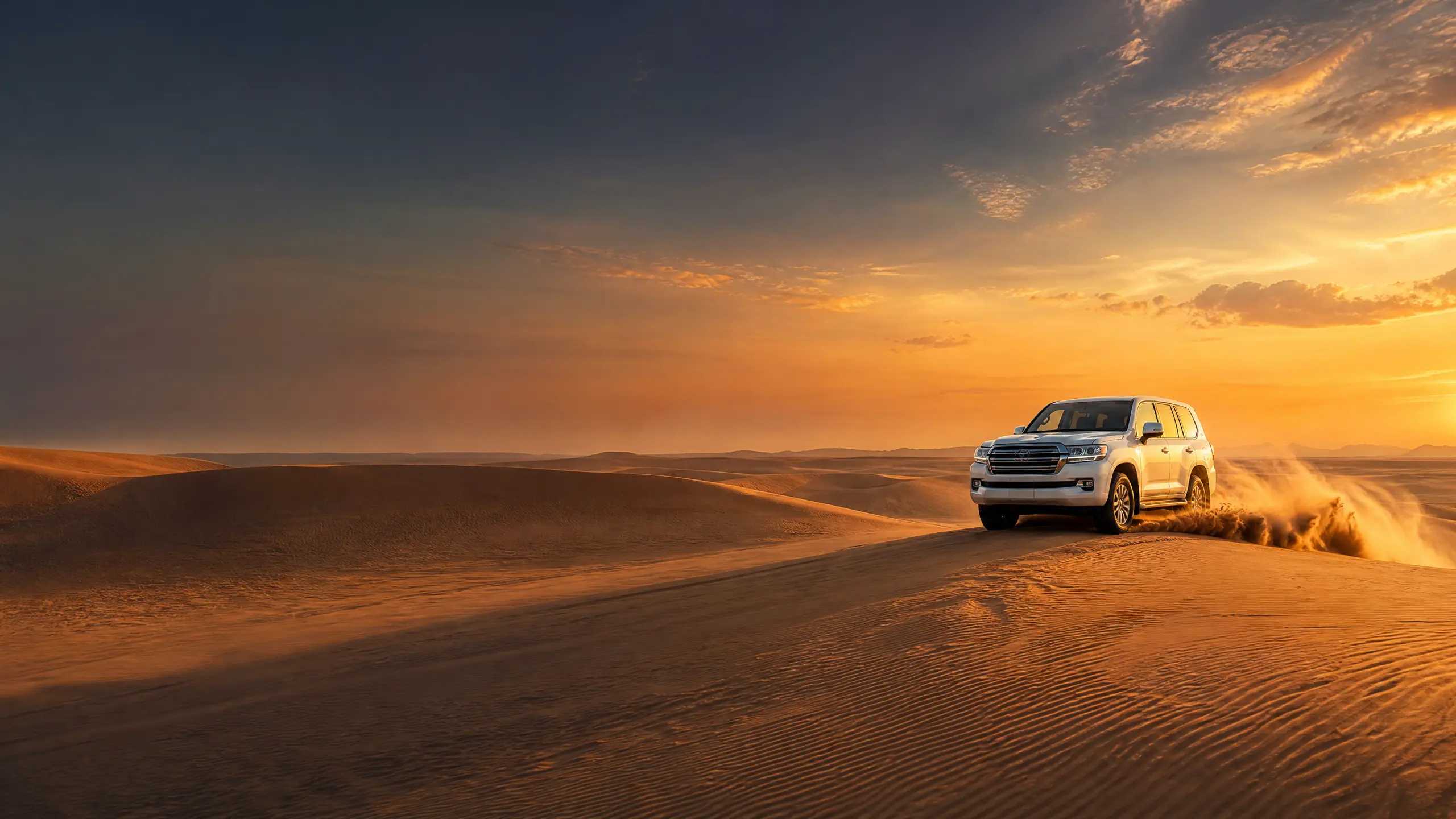 White Toyota Land Cruiser dune bashing across the Abu Dhabi desert in golden sand
